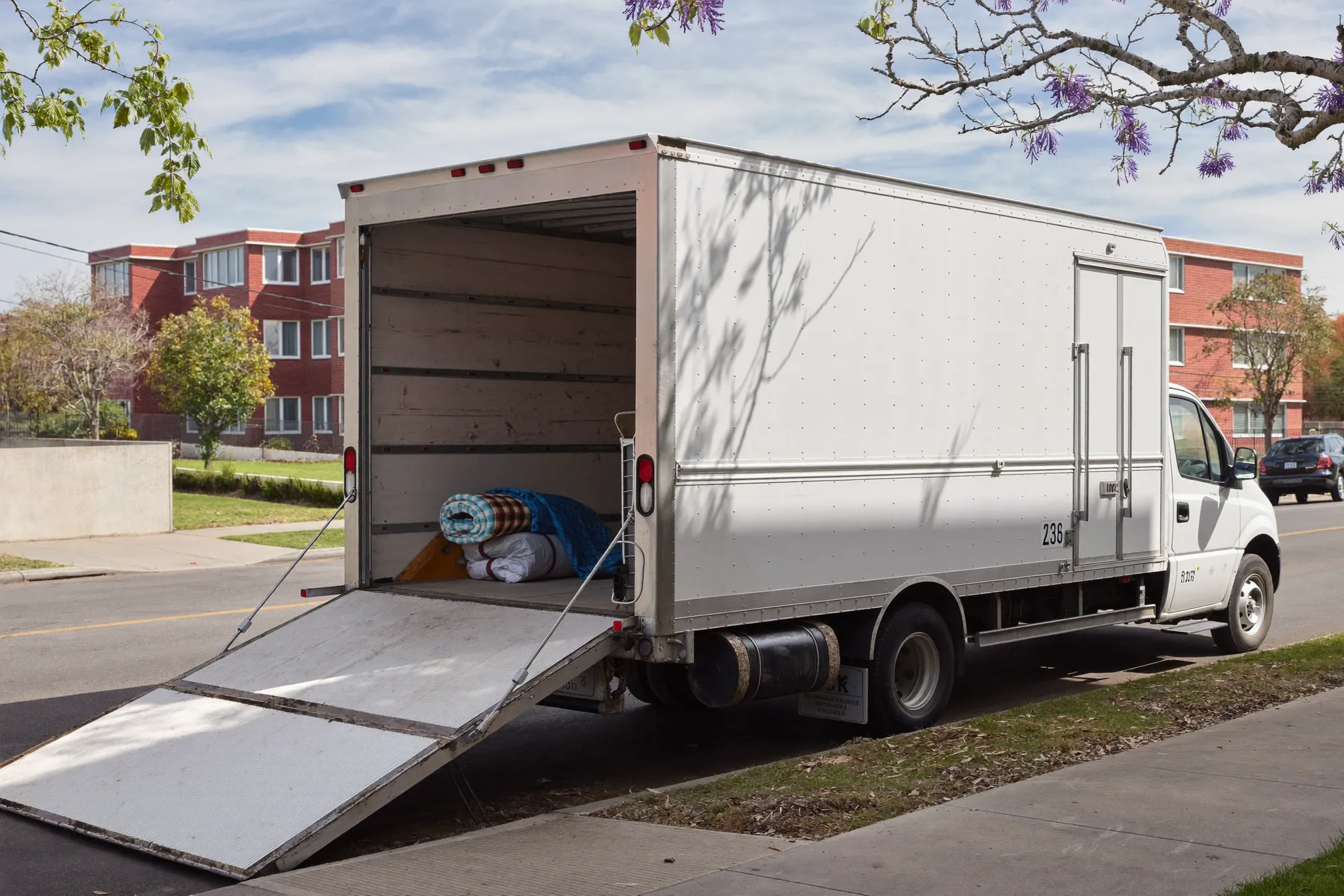 Moving truck loading outside an apartment building